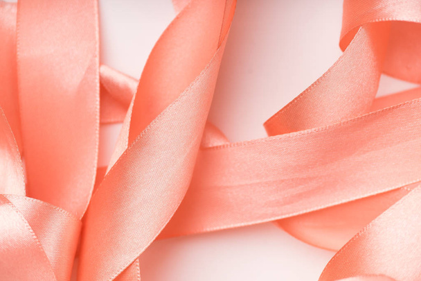 pink silk ribbons curled in spirals on white background  - 写真・画像
