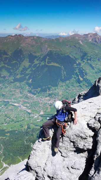 mountain climber on his way to the summit of Eiger mountain in the Swiss Alps - Фото, изображение