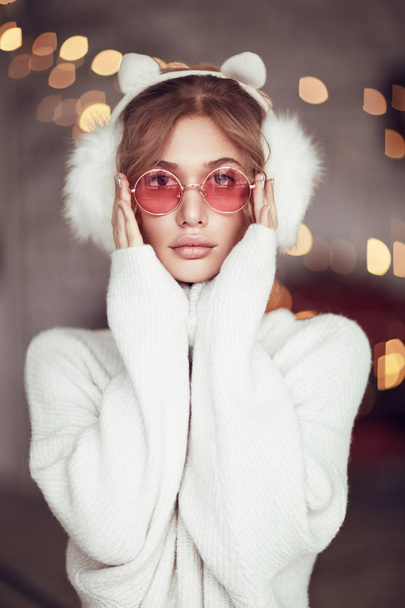 Woman in sunglasses and warming headphones - Valokuva, kuva