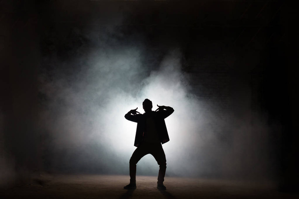 rapper dancing isolated on black background - Foto, afbeelding