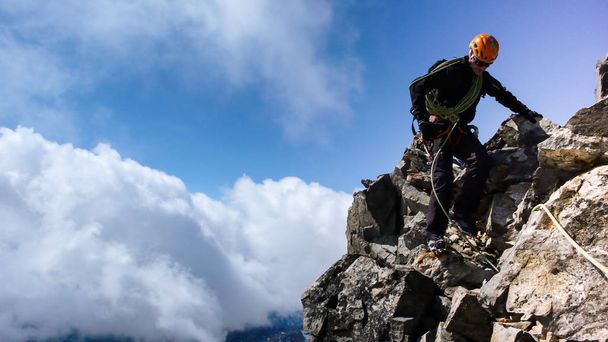 guide de montagne sur une crête du sommet rocheux sous le ciel bleu
 - Photo, image