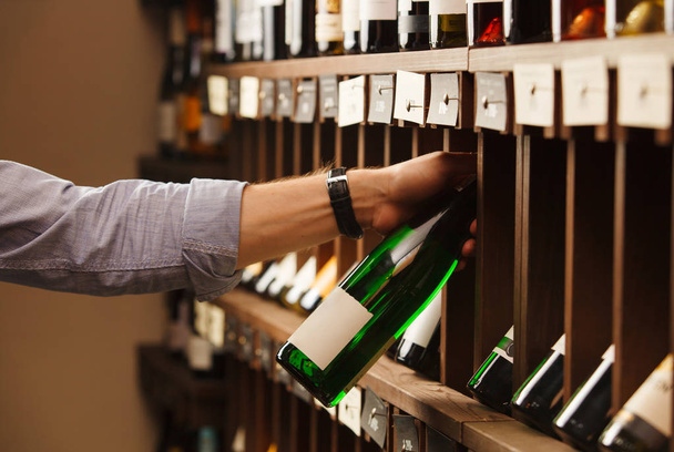 Expert in winemaking choose elite white wine in cellar. - Foto, imagen