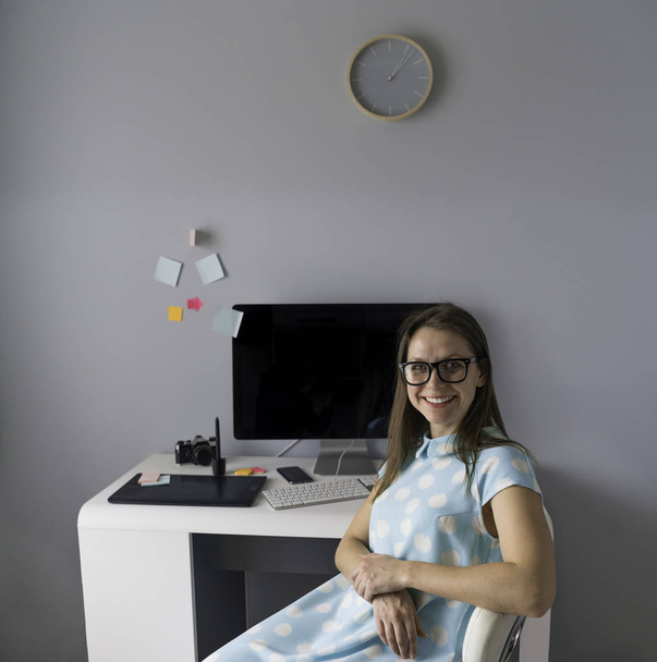 Casual graphic designer is sitting at her workplace in creative  - Photo, Image