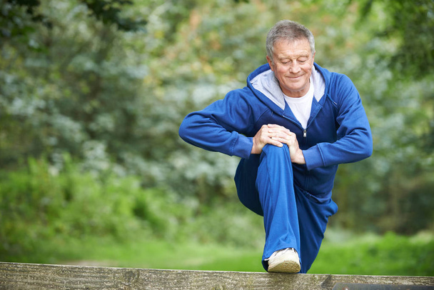 Senior Man Stretching On Countryside Run - Foto, Imagen