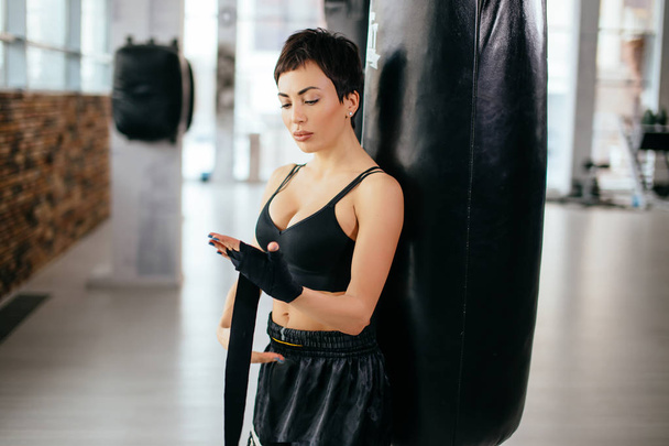 sexy sportswoman get prepared to the fight at sports hall - 写真・画像