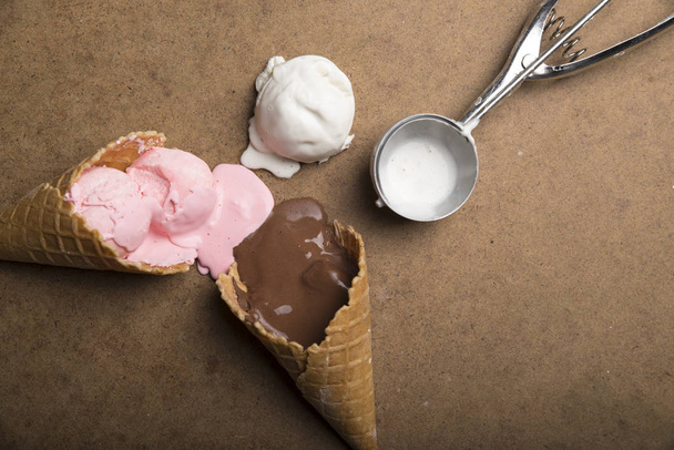 Variety of ice cream scoops in cones with chocolate, vanilla and strawberry - Photo, Image