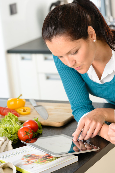 Woman looking tablet reading recipe kitchen vegetables - Foto, Imagen