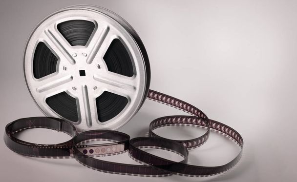 Old motion picture film reel on brown background - Photo, Image