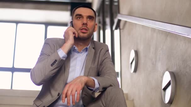 businessman calling on smartphone at office stairs - Video, Çekim