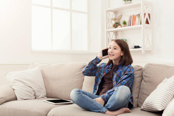 Young girl at home talking on mobile phone - Photo, Image