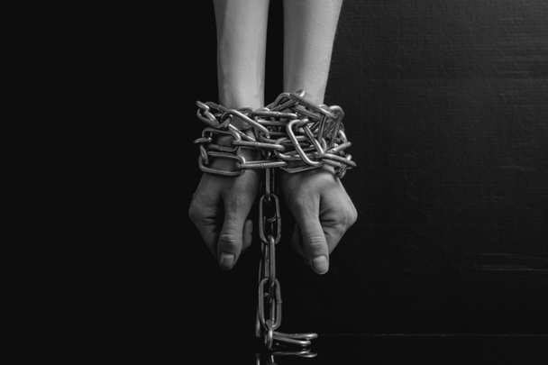 Imagen minimalista en blanco y negro. manos de las mujeres encadenadas de cerca sobre un fondo negro, tonificado a una película retro
 - Foto, Imagen