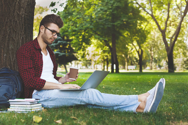 Handsome man with laptop and coffee outdoors - Fotoğraf, Görsel