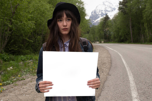 Il tuo testo qui.Viaggio e autostop concetto. Ritratto di felice bella giovane donna in piedi con vuoto vuoto
. - Foto, immagini