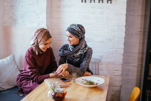 Two Muslim women in cafe, friends meeting - Photo, Image
