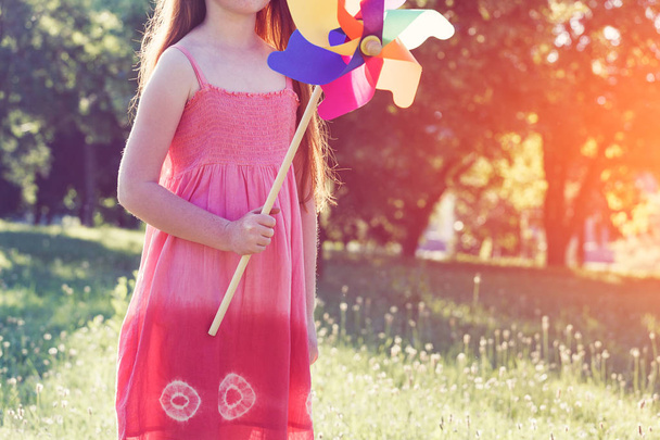 girl with pinwheel toy in park - Photo, image