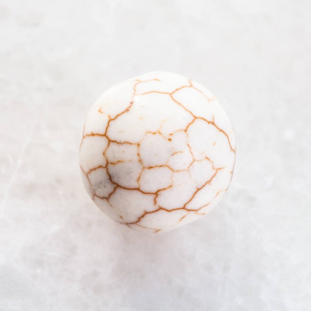 ball from cracked Cacholong gemstone on white - Фото, изображение