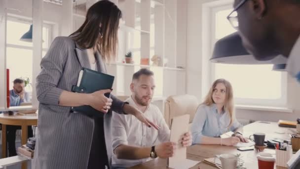 Camera follows female CEO motivating workers. Woman boss chats with colleagues, gives them directions in loft office 4K. - Felvétel, videó