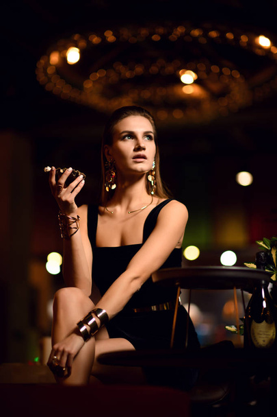 Beautiful sexy fashion brunette woman in expensive interior restaurant eat oyster waiting - Zdjęcie, obraz