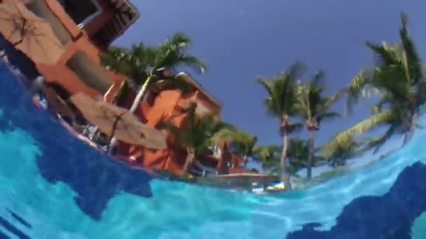 A camera placed underwater in a swimming pool - Felvétel, videó