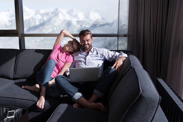 couple relaxing at  home using laptop computers - 写真・画像