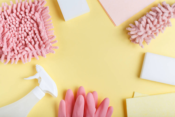 flat lay, cleaning tools on yellow background, sponges, rags, pi - 写真・画像