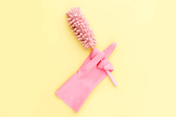 humorous cleaning concept, soft brush for dust in rubber gloves  - Valokuva, kuva