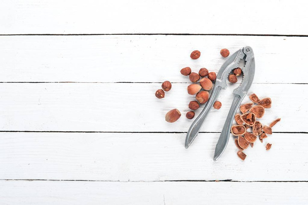 Nutcracker with Nuts. Hazelnut. On a wooden background. Top view. Copy space for your text. - Photo, Image