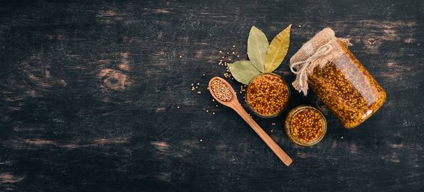 Grain Mustard. Spices On a dark wooden background. Top view. Copy space for your text. - Valokuva, kuva