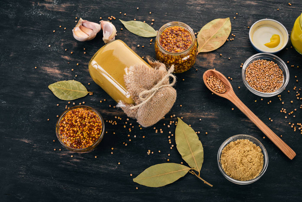 A set of mustard and spice. On a wooden background. Top view. Copy space for your text. - Foto, imagen