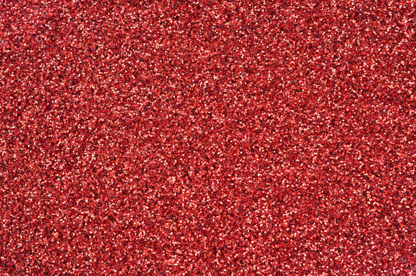 A huge amount of red decorative sequins. Background texture with shiny, small elements that reflect light in a random order. Glitter texture - Photo, Image