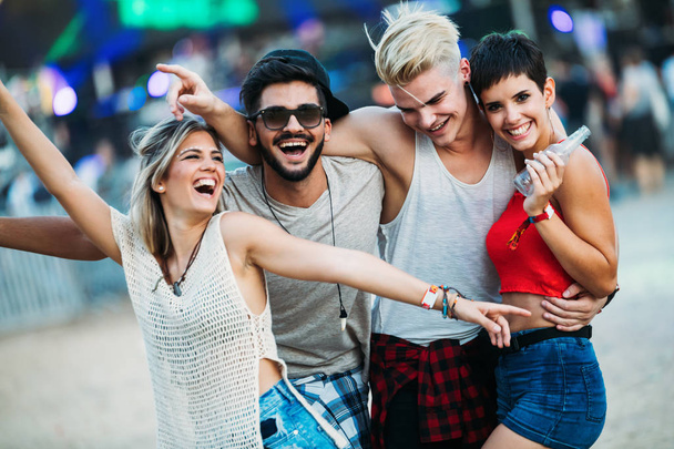 Group of young friends having fun time at music festival - Foto, Imagen