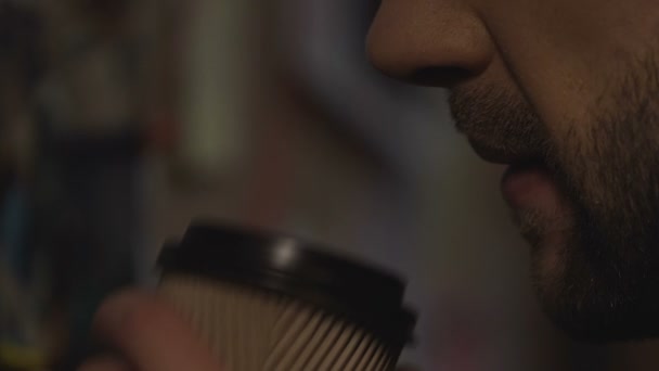 Bearded male officer drinking coffee and thinking about attempted crime, ideas - Footage, Video
