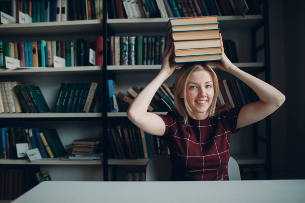 Young beautiful blond student girl with books - Valokuva, kuva