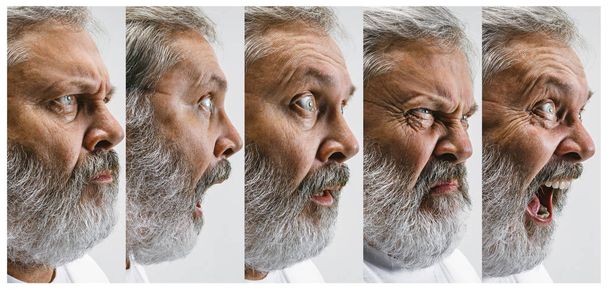 Starší atraktivní muž hledá překvapil izolované na bílém - Fotografie, Obrázek