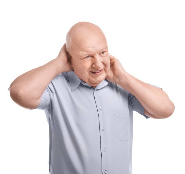 Senior man suffering from headache on white background. Enduring pain - Photo, image