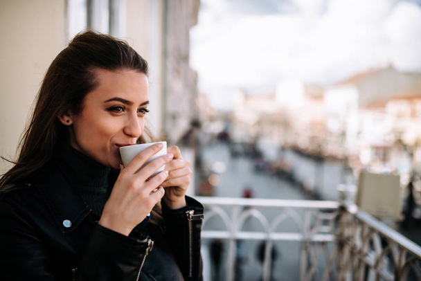 Closeup of cute girl relaxing on terrace with cup of coffee. - Zdjęcie, obraz