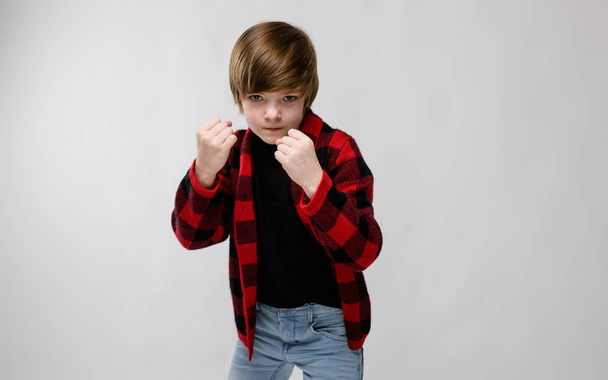 Nice preteen caucasian boy in casual outfit showing different expressions on white wall in studio. - Valokuva, kuva