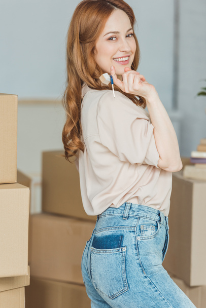smiling woman with keys from new apartment in hand, relocation concept - Photo, Image