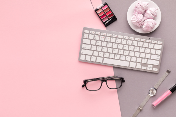 Working space with keyboard on pink background - Photo, Image