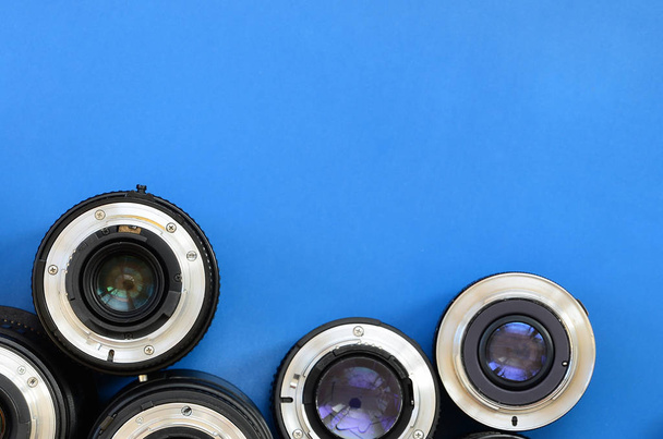 Varios lentes fotográficos se encuentran sobre un fondo azul brillante. Espacio para texto
 - Foto, imagen