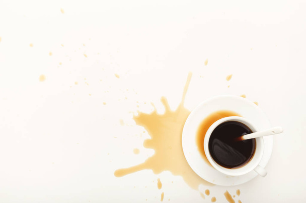 Filiżanka kawy i rozlanego espresso na białym tle - Zdjęcie, obraz