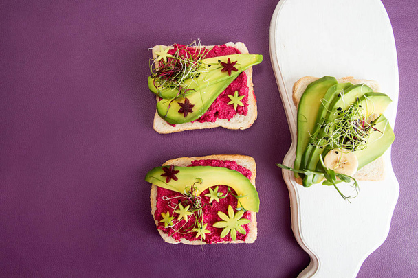 Healthy breakfast toast with feta, beetroot, slices of avocado a - Photo, Image