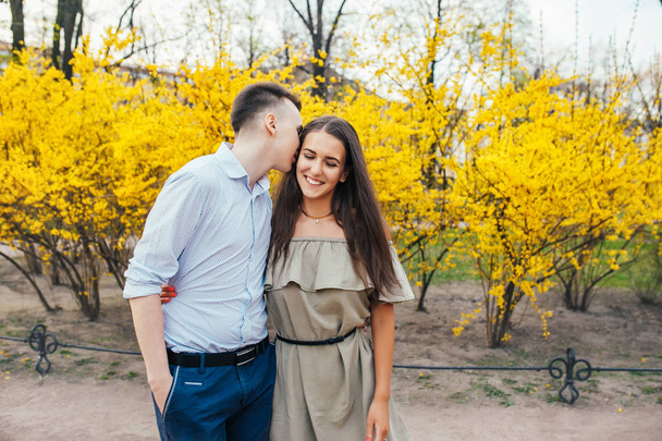Romantic couple having a date on a spring day with beautiful blossoms in the background. Romantic date or traveling couple concept - Фото, зображення
