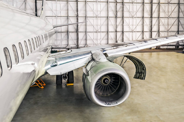 Aircraft service on repair diagnostics, inspection, view of the open engine hood and the fuselage of the airplane in the hangar. - Photo, Image