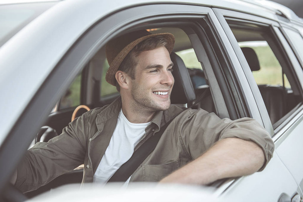 Optimistic guy is traveling on his automobile - Foto, Imagen