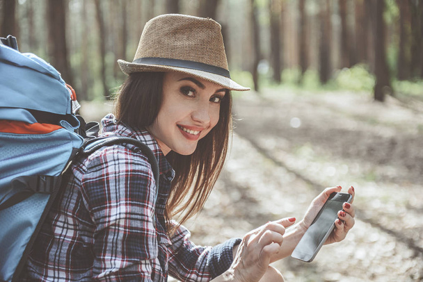 Optimistic girl is holding smartphone - Foto, Bild