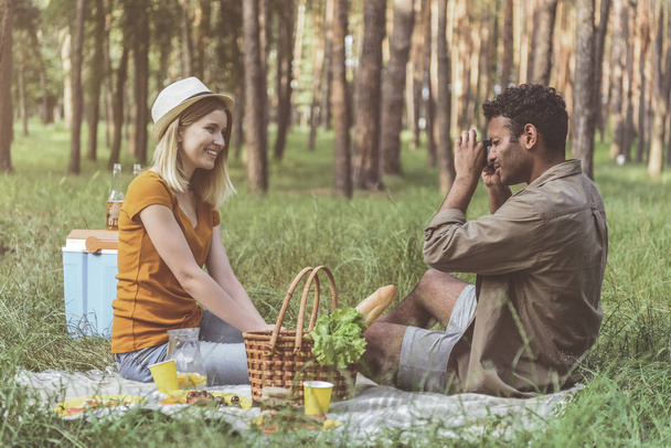 Enamored people relaxing in forest with joy - Foto, Imagen