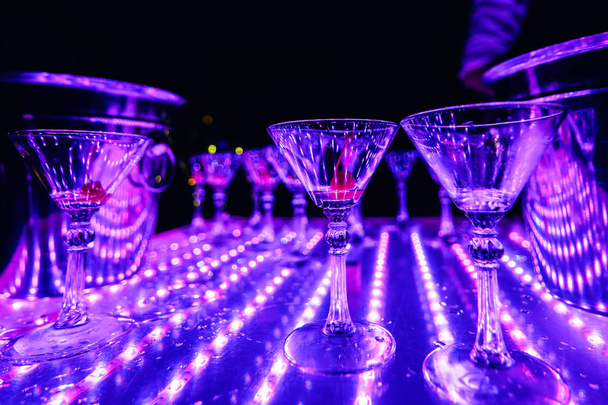 empty Martini glasses on table with lights in the restaurant - Photo, Image