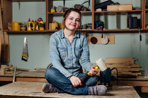 Portrait hardworking middle aged adult professional female carpenter worker workshop or garage. - Fotó, kép