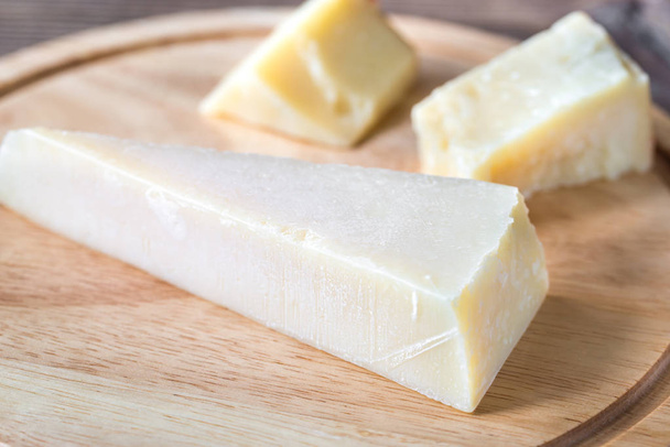 Grana Padano cheese on the wooden board - Photo, Image
